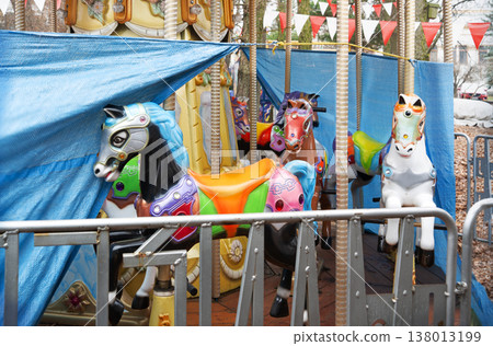 White ponies on an abandoned carousel 138013199