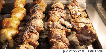 A ruddy kebab is being grilled on a barbecue 138013202