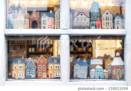 Small houses figurines in a window Small houses figurines in a window 138013209
