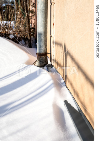 Winter Snow Around Exterior Wall And Metal Drainpipe Winter Snow Around Exterior Wall And Metal Drainpipe 138013469