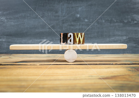 LAW Balance Concept Shown By Letter Blocks On Wooden Seesaw LAW Balance Concept Shown By Letter Blocks On Wooden Seesaw 138013470