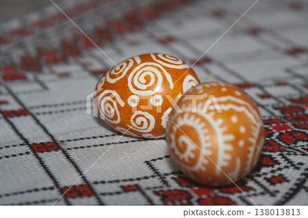 Two traditional Ukrainian pysanky on an embroidered tablecloth Two traditional Ukrainian pysanky on an embroidered tablecloth 138013813
