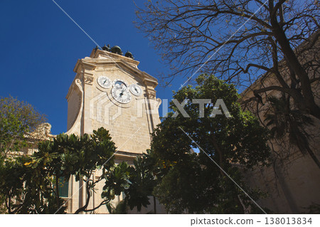 The historic Grandmaster's Palace clock tower in Valletta Malta under a deep blue sky 138013834