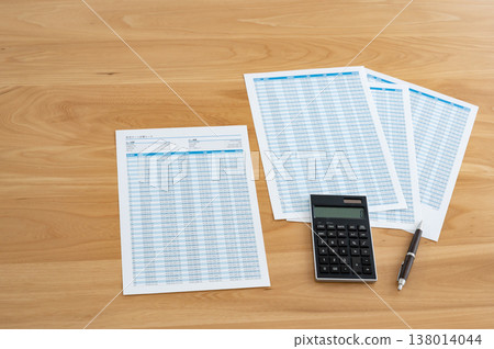 Loan calculation sheet, calculator, and pen on the desk 138014044