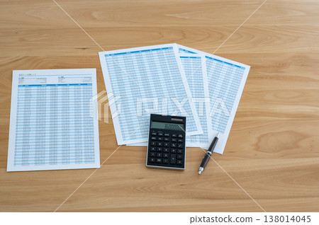 Loan calculation sheet, calculator, and pen on the desk Loan calculation sheet, calculator, and pen on the desk 138014045