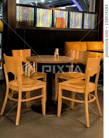 A cozy wooden table in the interior of a cafe or bar 138014283