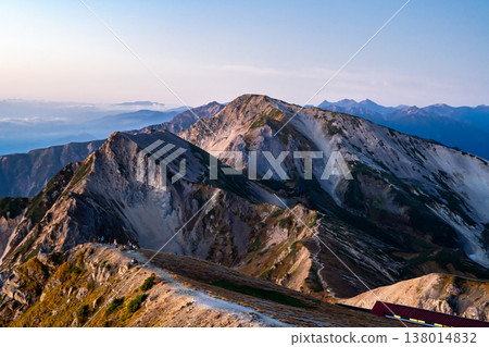 Early morning view of Mt. Hakuba-Yari and Mt. Shakushi (Morgenrot) from Mt. Hakuba. Traverse hike from Mt. Hakuba to Mt. Yukikura in the Northern Alps. Early morning view of Mt. Hakuba-Yari and Mt. Shakushi (Morgenrot) from Mt. Hakuba. Traverse hike from Mt. Hakuba to Mt. Yukikura in the Northern Alps. 138014832