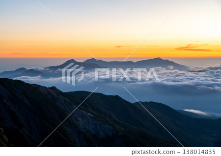 The magic hour view of the Kubiki Sanzan (Yakeyama, Hiuchiyama, and Myokoyama) from Mt. Shirouma. A traverse of the Northern Alps from Mt. Shirouma to Mt. Yukikura. The magic hour view of the Kubiki Sanzan (Yakeyama, Hiuchiyama, and Myokoyama) from Mt. Shirouma. A traverse of the Northern Alps from Mt. Shirouma to Mt. Yukikura. 138014835