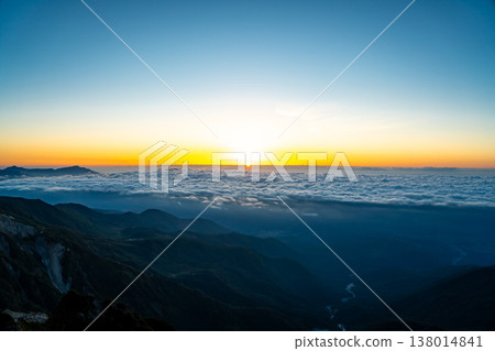 Magic hour view of Mt. Myoko and the sunrise from Mt. Shirouma. Traverse hike from Mt. Shirouma to Mt. Yukikura in the Northern Alps. Magic hour view of Mt. Myoko and the sunrise from Mt. Shirouma. Traverse hike from Mt. Shirouma to Mt. Yukikura in the Northern Alps. 138014841