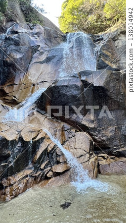 A natural landscape of waterfalls cascading down rocky cliffs and clear streams. A natural landscape of waterfalls cascading down rocky cliffs and clear streams. 138014942