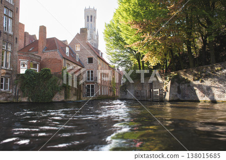 View from the water of historic brick houses and the Belfry of Bruges tower in Bruges, Belgium 138015685