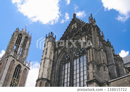 Ornate facade and tower of St. Martin's Cathedral in Utrecht against a blue sky Ornate facade and tower of St. Martin's Cathedral in Utrecht against a blue sky 138015722