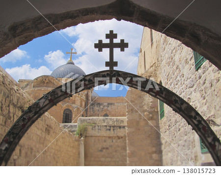 View of the Church of the Holy Sepulchre through an ornate arch in Jerusalem 138015723
