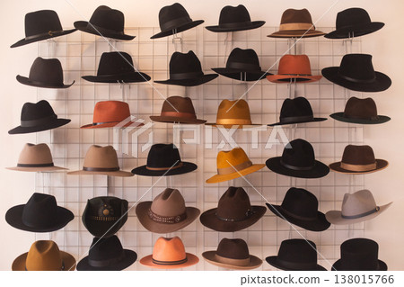 Large display wall of varied fedora and cowboy hats 138015766