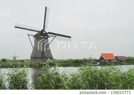 Historic windmills of Kinderdijk along a canal in the Netherlands 138015771