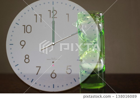 A clock and hourglass at 12 o'clock A clock and hourglass at 12 o'clock 138016089