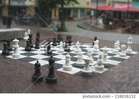 Outdoor giant chess set on a city square with tilt-shift effect Outdoor giant chess set on a city square with tilt-shift effect 138016132