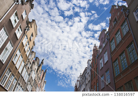 Dynamic low-angle view of historic tenement houses framing a mackerel sky in Gdansk, Poland 138016597