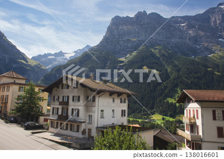 Scenic view of a Swiss mountain village with traditional chalets and Alpine peaks 138016601