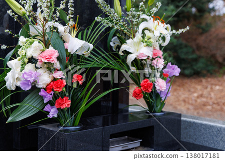 Flowers offered at a grave on a rainy day Flowers offered at a grave on a rainy day 138017181