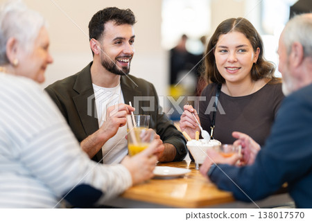 Family day. Multiage family drink coffee or juice in restaurant Family day. Multiage family drink coffee or juice in restaurant 138017570