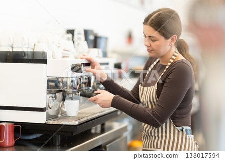 Girl coffee shop employee at work Girl coffee shop employee at work 138017594