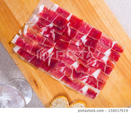 Sliced cured ham is served on board Sliced cured ham is served on board 138017619