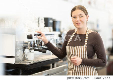 Woman barista making coffee 138017633
