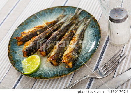 Grilled pilchards served with slice of lemon for dinner 138017674