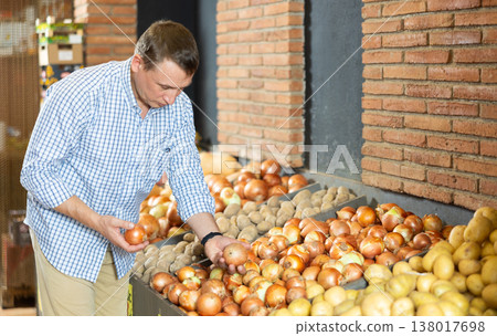 Male customer made beeline for fresh produce section, pick up onion for morning salad 138017698