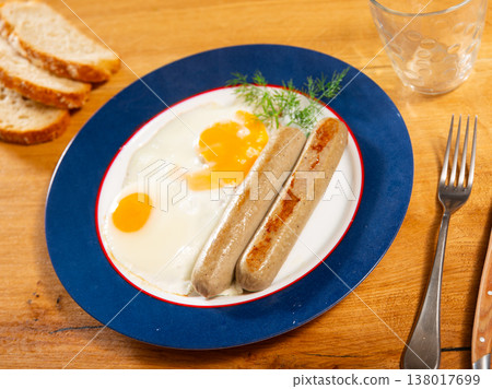 Delicious hearty breakfast with scrambled eggs and sausage closeup Delicious hearty breakfast with scrambled eggs and sausage closeup 138017699