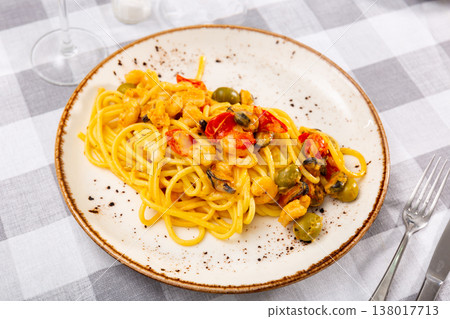 Pasta with seafood and olives served on platter Pasta with seafood and olives served on platter 138017713