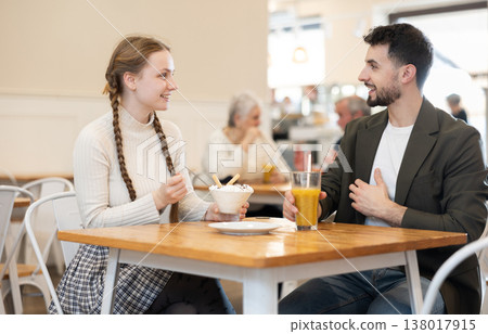 Father and teenage daughter sitting at table in cafe Father and teenage daughter sitting at table in cafe 138017915