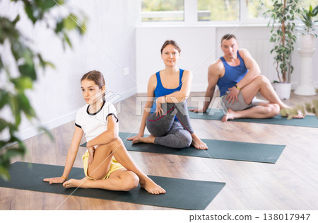 Family performing yoga exercises at yoga studio, family health concept 138017947