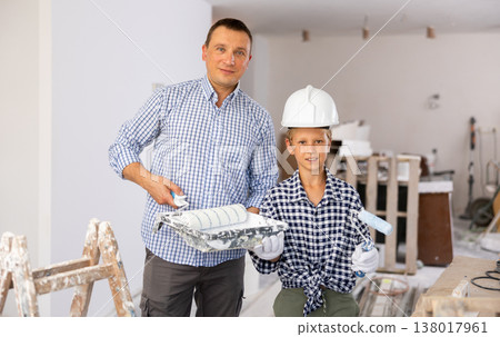 Smiling boy and father holding paint rollers, home improvement works 138017961