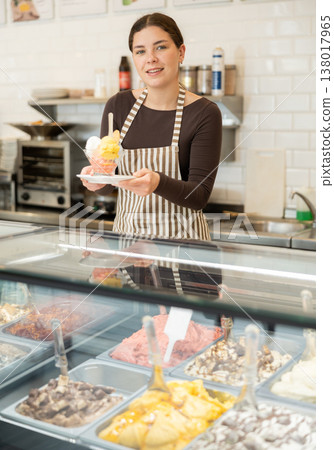 woman on a cafe seller offers ice cream woman on a cafe seller offers ice cream 138017965