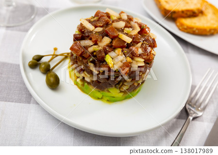Tartare is dish of pieces of raw tuna and avocado cubes, seasoned with soy and Worcestershire sauce Tartare is dish of pieces of raw tuna and avocado cubes, seasoned with soy and Worcestershire sauce 138017989
