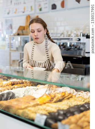 Teenage girl works part time in a bakery Teenage girl works part time in a bakery 138017991