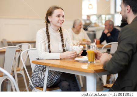 Teenage girl at a meeting with her dad in a cafe Teenage girl at a meeting with her dad in a cafe 138018035