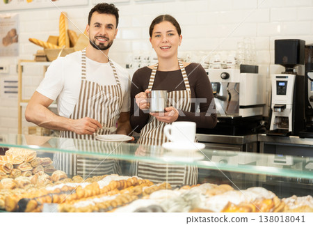 Two cafe employees preparing coffee and delicious pastries 138018041