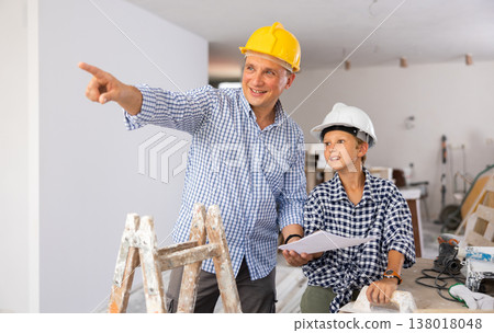 Father and son talking about space planning in new apartment Father and son talking about space planning in new apartment 138018048