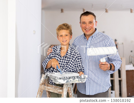 Boy with father holding renovating home tools 138018192