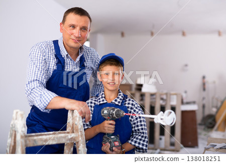 Boy with father holding renovating home tools 138018251