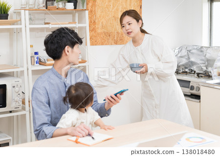 A young father and his family: childcare and answering phone calls while working from home, while trying to keep his grumpy wife happy. A young father and his family: childcare and answering phone calls while working from home, while trying to keep his grumpy wife happy. 138018480