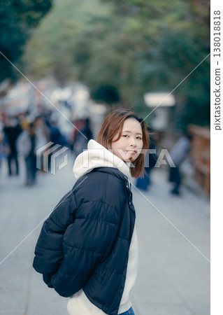 A sightseeing scene of two women in their 20s walking together at a shrine. A sightseeing scene of two women in their 20s walking together at a shrine. 138018818