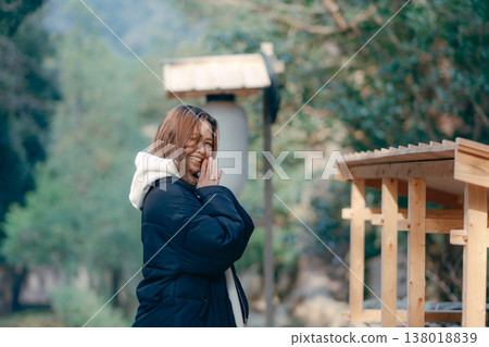 A scene of a woman in her 20s praying at a shrine. A scene of a woman in her 20s praying at a shrine. 138018839
