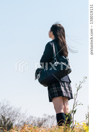 An emotional scene of adolescence: the backs of high school students (faceless) gazing towards the future. 138019131