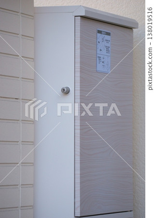 A delivery box located in front of the entrance of a detached house. A delivery box located in front of the entrance of a detached house. 138019516