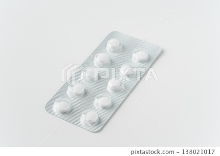 A sheet of tablets against a white background. 138021017