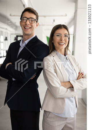 Male, female team members posing confidently in office Male, female team members posing confidently in office 138021133